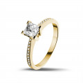0.75 carat solitaire ring in yellow gold with princess diamond and side diamonds