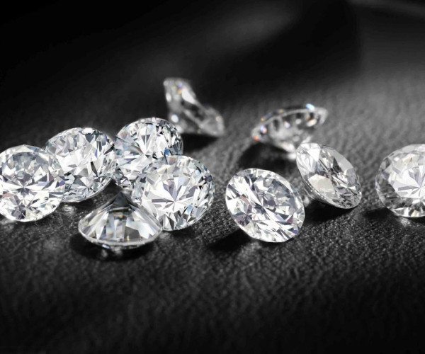 A stunning arrangement of sparkling diamonds elegantly displayed on a luxurious black leather surface.