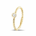0.07 carat diamond stackable twisted ring in yellow gold