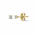 0.30 carat classic diamond earrings in yellow gold with four prongs