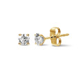 1.00 carat classic diamond earrings in yellow gold with four prongs