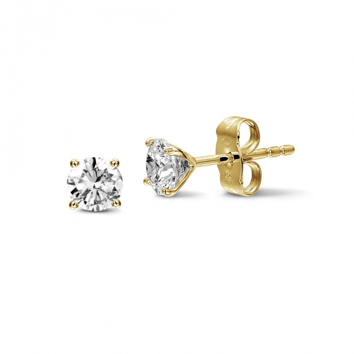 1.50 carat classic diamond earrings in yellow gold with four prongs