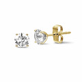 2.00 carat classic diamond earrings in yellow gold with four prongs