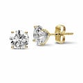 2.50 carat classic diamond earrings in yellow gold with four prongs