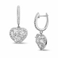 1.35 carat heart-shaped earrings in white gold with round diamonds