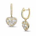 1.35 carat heart-shaped earrings in yellow gold with round diamonds