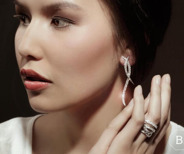 Woman wearing diamond earrings from the Nathu collection