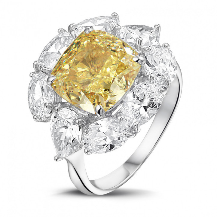 Entourage ring in white gold with ‘fancy intense yellow’ cushion diamond and oval and pear shaped  diamonds