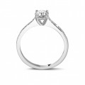 0.50 carat solitaire ring in platinum with four prongs and side diamonds