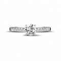 0.50 carat solitaire ring in platinum with four prongs and side diamonds