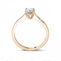 0.50 carat solitaire ring in red gold with four prongs and side diamonds