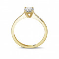 0.50 carat solitaire ring in yellow gold with four prongs and side diamonds