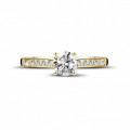 0.50 carat solitaire ring in yellow gold with four prongs and side diamonds
