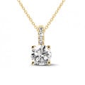0.50 carat solitaire pendant in yellow gold with four prongs and round diamonds