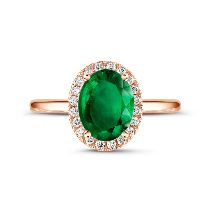 Halo anillo en oro rojo con esmeralda ovalada