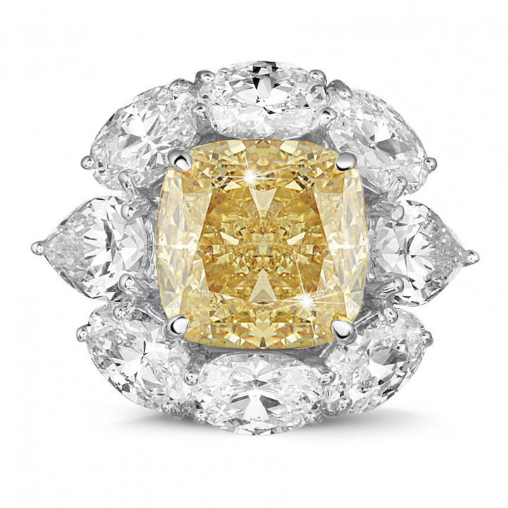 Anillo « entourage » en oro blanco con un diamante 'amarillo intenso fantasía' de talla cojín y diamantes en forma ovalado y de pera