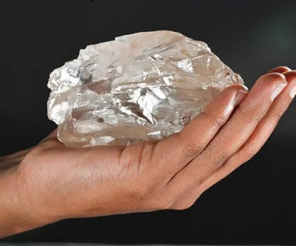 Gros plan d'une personne tenant le deuxième plus gros diamant du monde, trouvé au Botswana