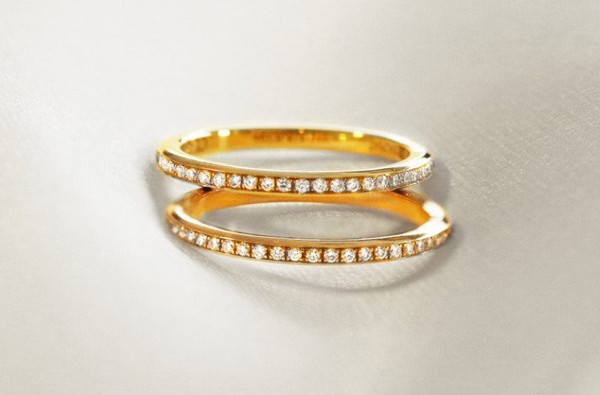 Two elegant gold engagement rings with thin bands adorned with diamonds in yellow gold