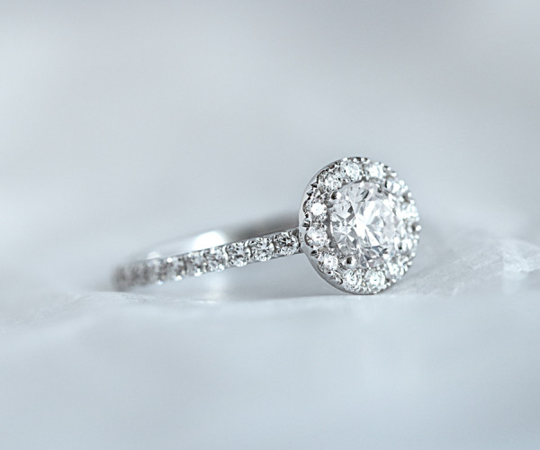 A beautiful platinum engagement ring featuring a sparkling diamond, displayed on a pristine white background
