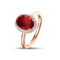 Halo ring in red gold with an oval ruby