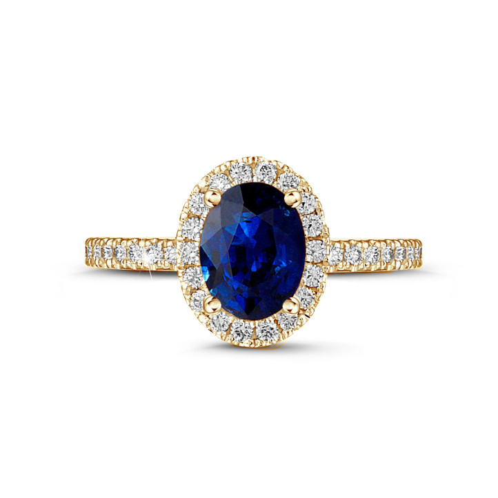 Halo solitaire ring in yellow gold with an oval sapphire and small diamonds