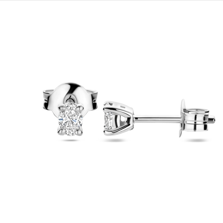 0.30 carat solitaire earrings with oval cut diamonds in white gold