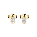 0.30 carat solitaire earrings with oval cut diamonds in yellow gold