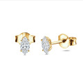 0.30 carat solitaire earrings with marquise cut diamonds in yellow gold