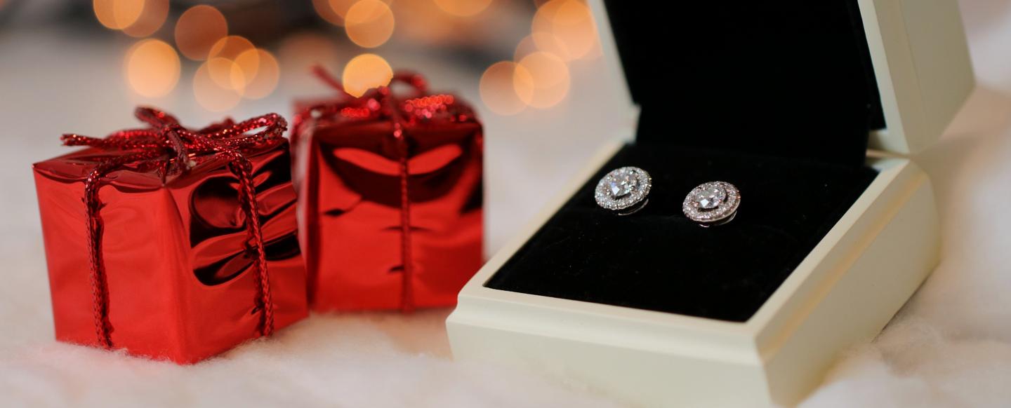 A pair of elegant round halo diamond studs, by BAUNAT.