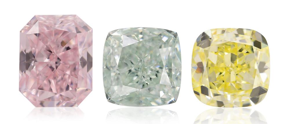Tres diamantes tallados cushion en rosa, verde claro y amarillo sobre fondo blanco