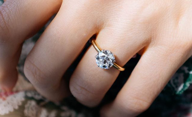 Goldener Solitär-Diamantring mit rundem Brillanten in Krappenfassung am Finger