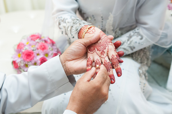 Man Places Wedding Ring on Bride's Hand