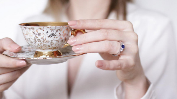 Mujer con un anillo con un anillo de compromiso de trilogía para mostrar como se ve el tamaño del diamante del anillo de compromiso.