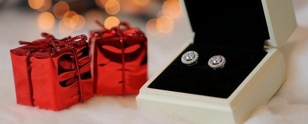 Festive red and white gift boxes showcasing elegant silver diamond earrings, perfect for a Christmas gift