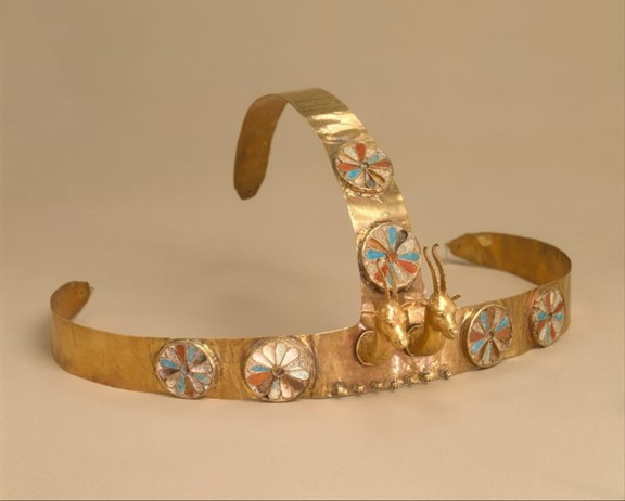  A decorative gold headband with vibrant patterns, showcasing two gazelle heads, reflecting ancient Egyptian aesthetics.