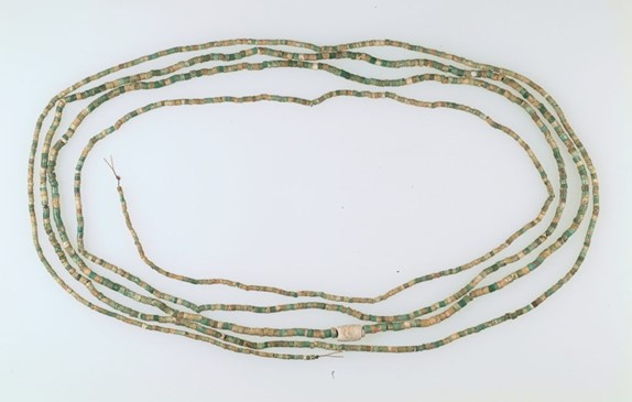 A necklace featuring green and blue beads, reminiscent of ancient Egyptian design elements.
