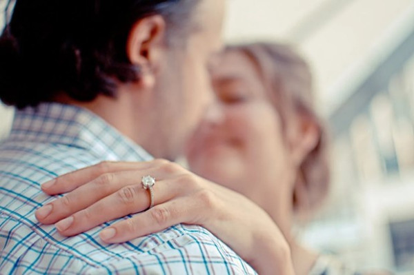 couple hugging after the husband did a marriage proposal with a stunning diamond engagement ring