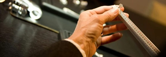 Close-up of a jeweller resizing a brilliant-cut diamond ring