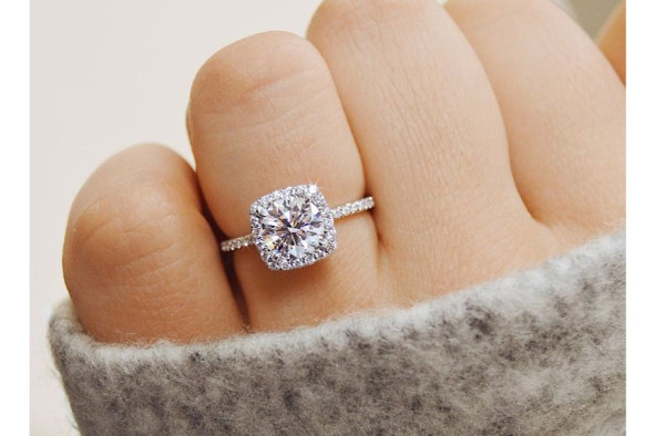 Woman wears an elegant engagement ring with diamond - BAUNAT