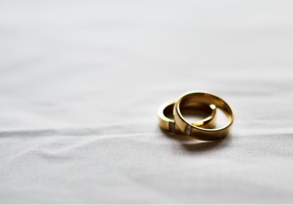 Two golden wedding bands with diamonds