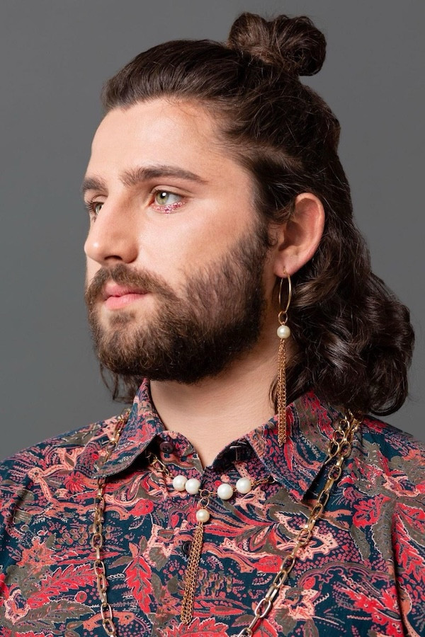 Man wearing pear jewellery