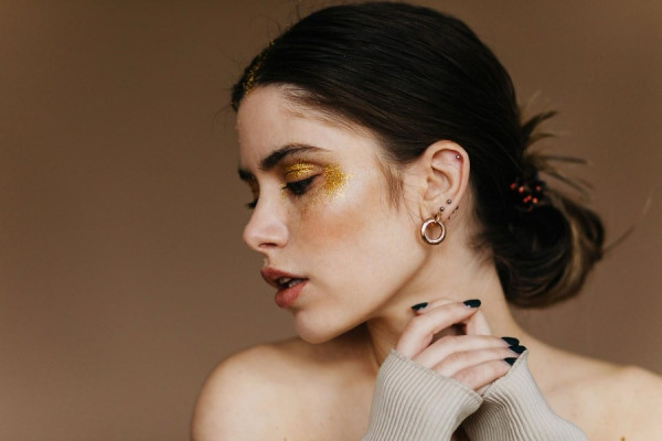 Woman wearring golden hoop earrings
