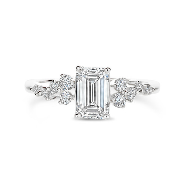 White gold engagement ring with emerald-cut center diamond and pavé side stones