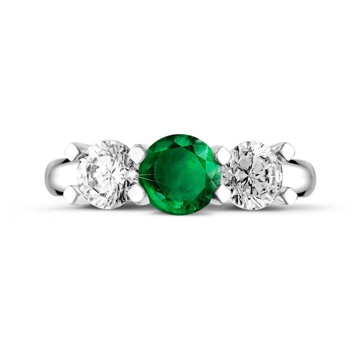 Trilogie ring in platina met centrale smaragd en 2 ronde diamanten